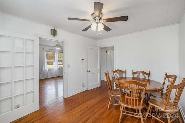 dining space with hardwood / wood-style flooring, ceiling fan, and crown molding