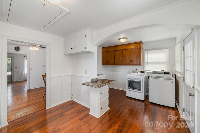 laundry area with dark hardwood / wood-style flooring, cabinets, a wealth of natural light, and independent washer and dryer