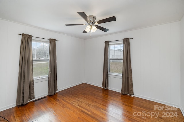 unfurnished room with hardwood / wood-style flooring, ceiling fan, and plenty of natural light