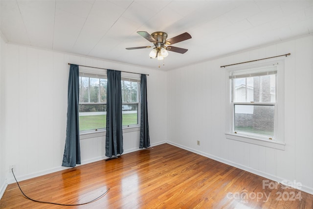 empty room with hardwood / wood-style flooring and ceiling fan