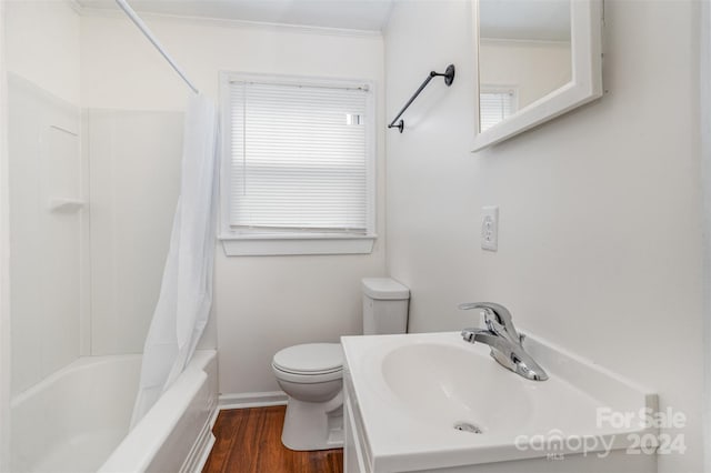 full bathroom with toilet, hardwood / wood-style floors, ornamental molding, vanity, and shower / bath combination with curtain