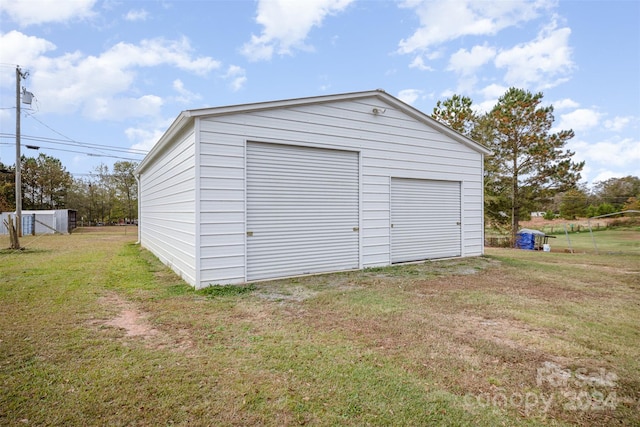 garage featuring a yard