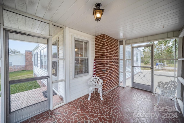 sunroom / solarium featuring a healthy amount of sunlight