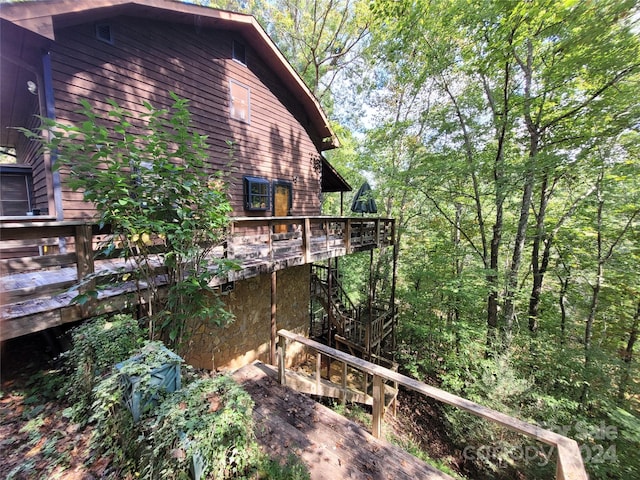 view of property exterior featuring a wooden deck