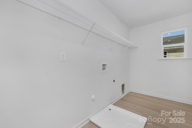 clothes washing area featuring hookup for a gas dryer, wood-type flooring, hookup for an electric dryer, and hookup for a washing machine