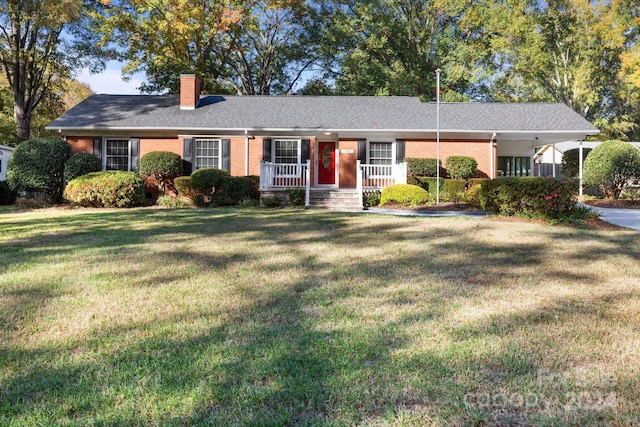 ranch-style house with covered porch and a front yard