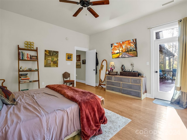 bedroom with light hardwood / wood-style floors, access to outside, and ceiling fan