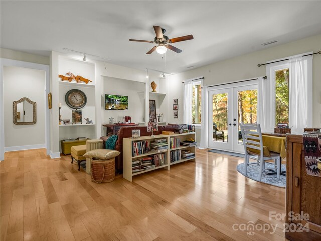 sitting room with french doors, ceiling fan, track lighting, and light wood-type flooring