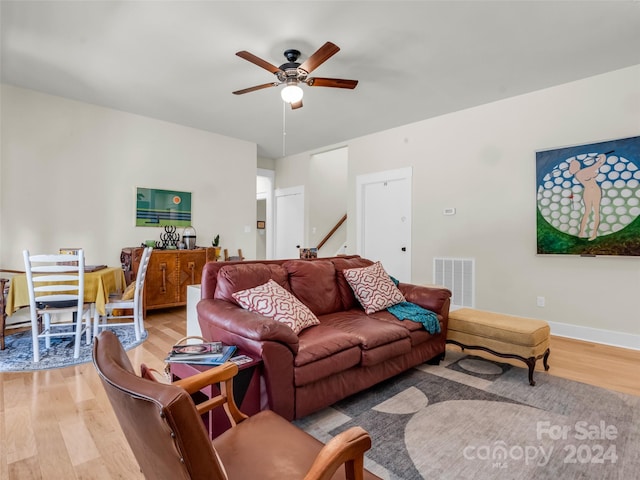 living room with ceiling fan and hardwood / wood-style flooring