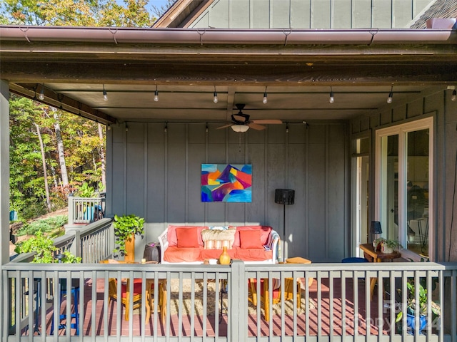 deck featuring outdoor lounge area and ceiling fan