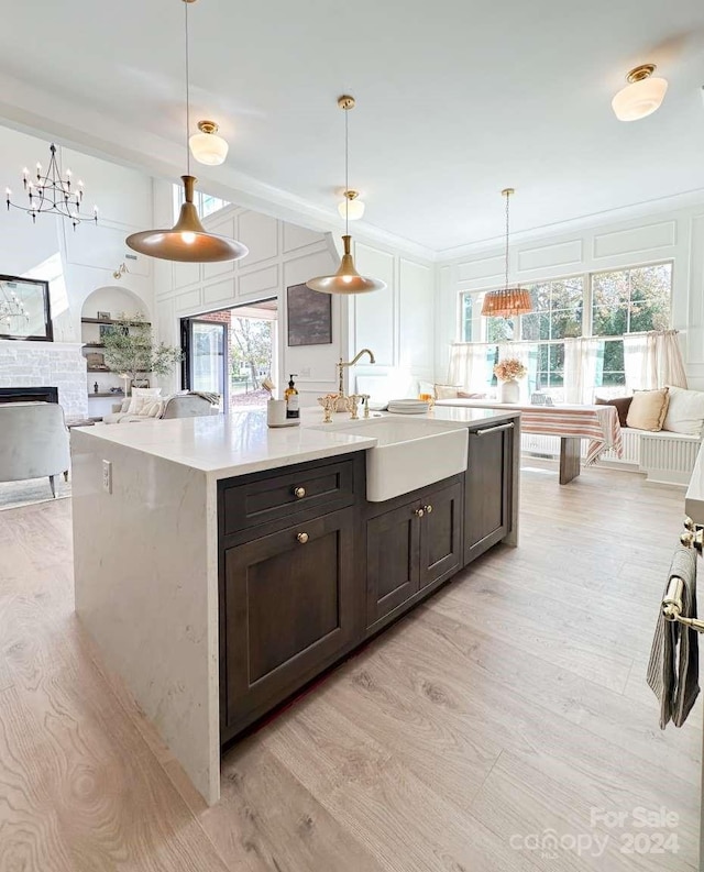 kitchen featuring light hardwood / wood-style floors, decorative light fixtures, and a wealth of natural light