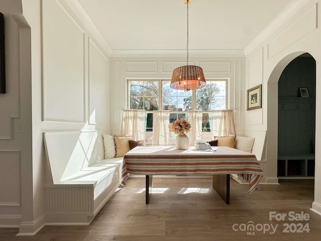 sitting room featuring crown molding and hardwood / wood-style flooring