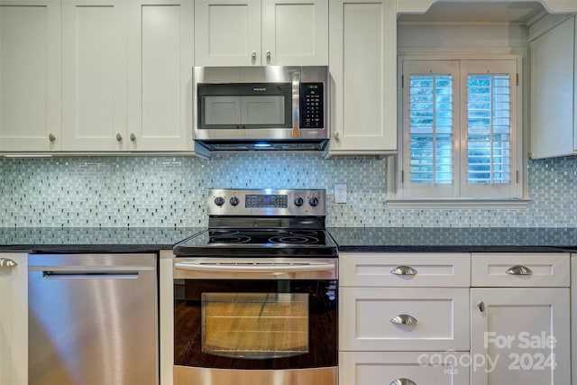 kitchen featuring white cabinets, tasteful backsplash, and stainless steel appliances