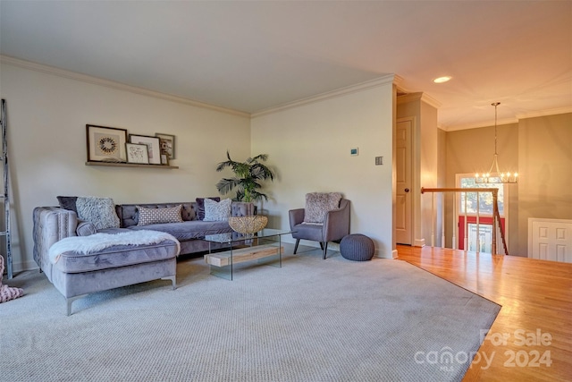 living room featuring crown molding, wood-type flooring, and a chandelier