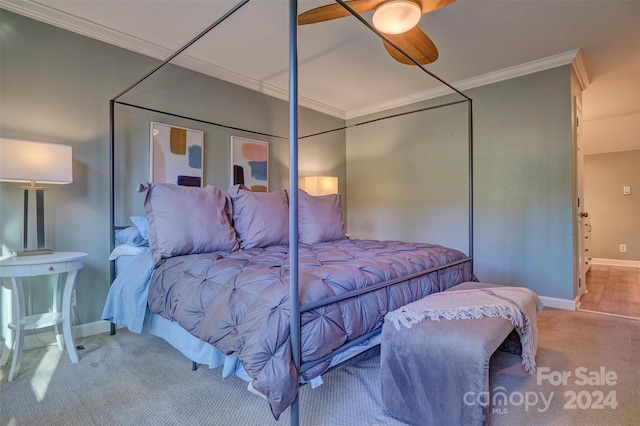 carpeted bedroom featuring ceiling fan and ornamental molding