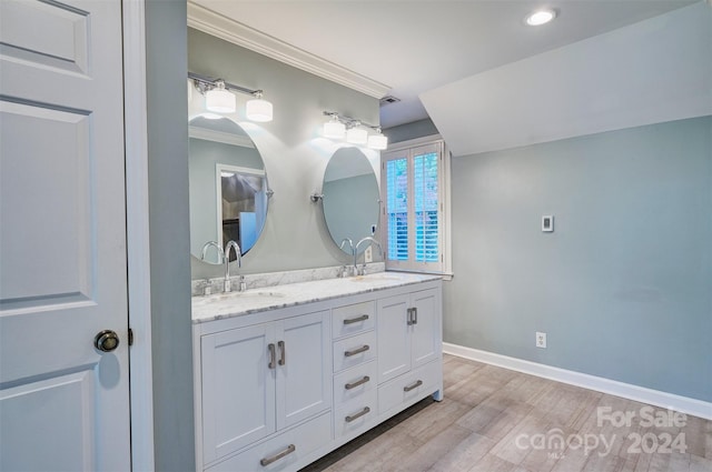 bathroom with vanity, crown molding, and wood-type flooring