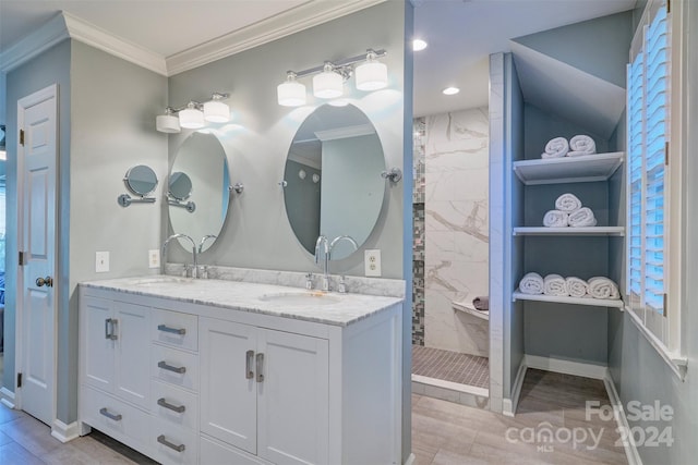 bathroom with vanity, ornamental molding, wood-type flooring, and tiled shower