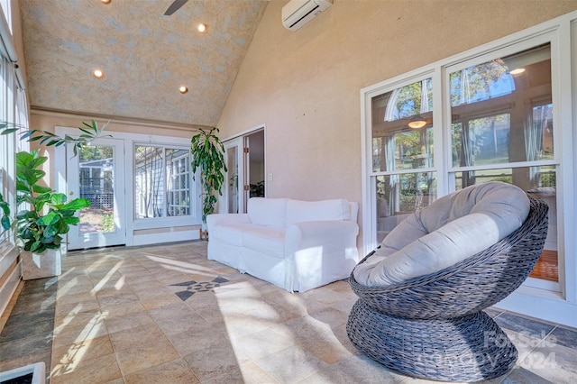 sunroom featuring lofted ceiling, an AC wall unit, and ceiling fan