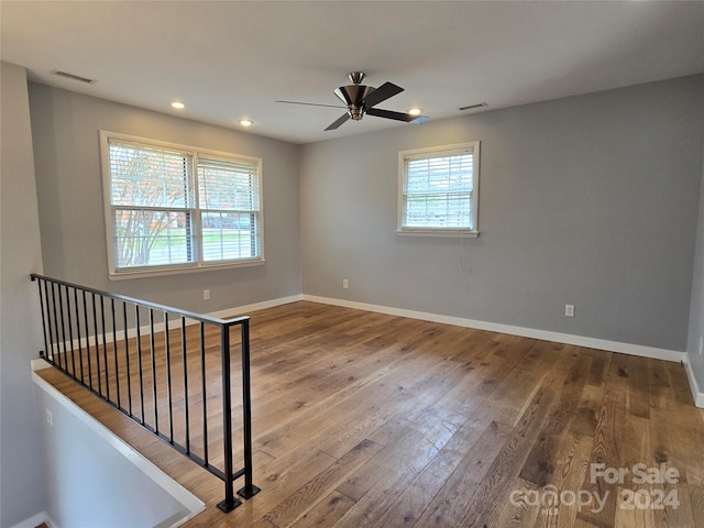 spare room featuring wood-type flooring and ceiling fan