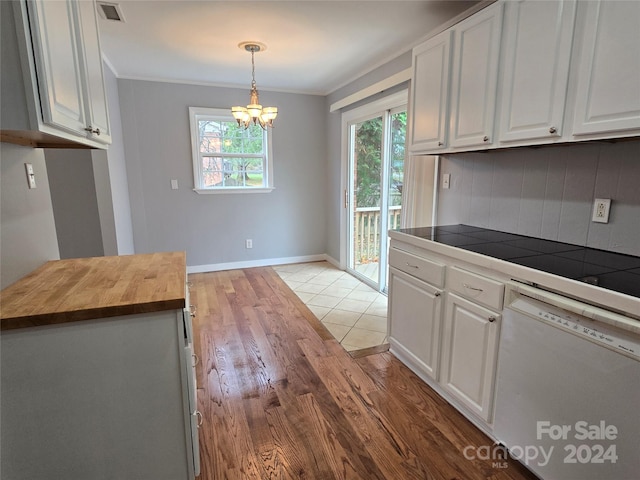 kitchen featuring hanging light fixtures, wood counters, white dishwasher, white cabinetry, and light hardwood / wood-style floors