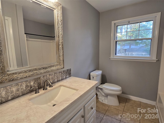 bathroom featuring vanity, toilet, and tile patterned flooring