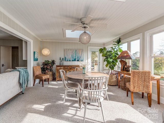 sunroom / solarium with a skylight, ceiling fan, and a healthy amount of sunlight