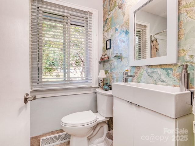 bathroom with tile patterned floors, vanity, and toilet