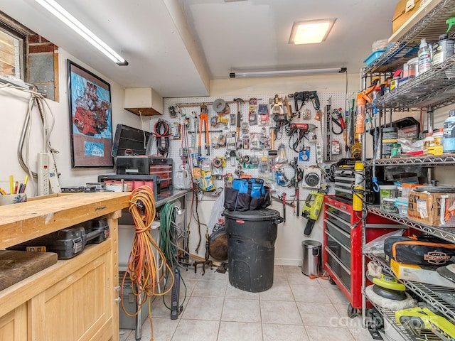 interior space featuring a workshop area and light tile patterned floors