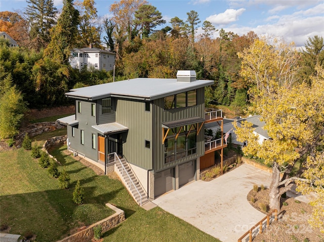 rear view of property featuring a yard and a garage