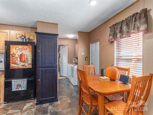 dining room with a textured ceiling and washing machine and dryer