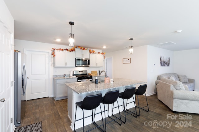 kitchen with stainless steel appliances, decorative light fixtures, dark hardwood / wood-style floors, and white cabinets