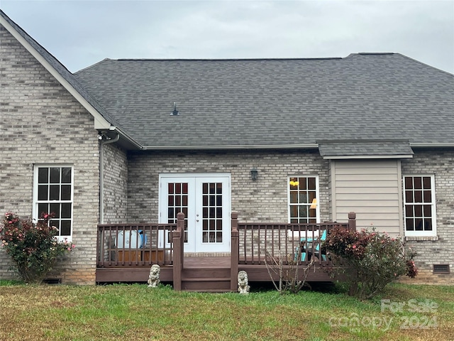 back of property with a deck and a yard