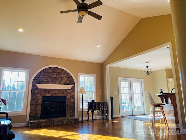 living room featuring french doors, lofted ceiling, hardwood / wood-style flooring, a fireplace, and ornamental molding