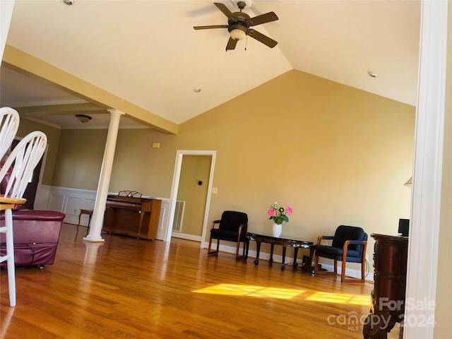 sitting room with hardwood / wood-style floors, vaulted ceiling, ceiling fan, and ornate columns