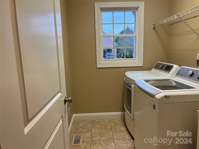 laundry area with washing machine and clothes dryer