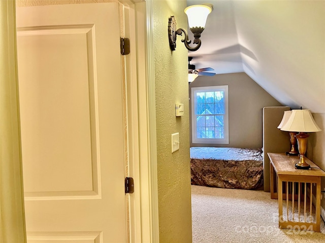 bedroom with carpet flooring, vaulted ceiling, and ceiling fan