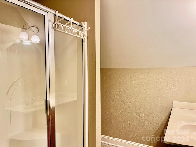 bathroom featuring vanity and an enclosed shower