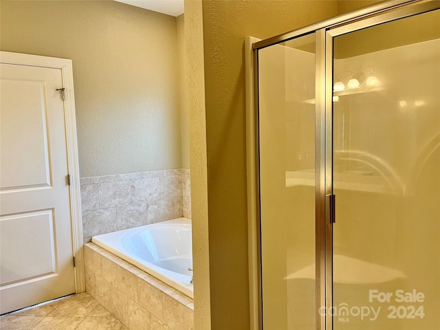 bathroom featuring tile patterned flooring and shower with separate bathtub