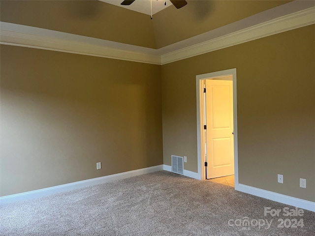 spare room with ceiling fan, ornamental molding, and light carpet