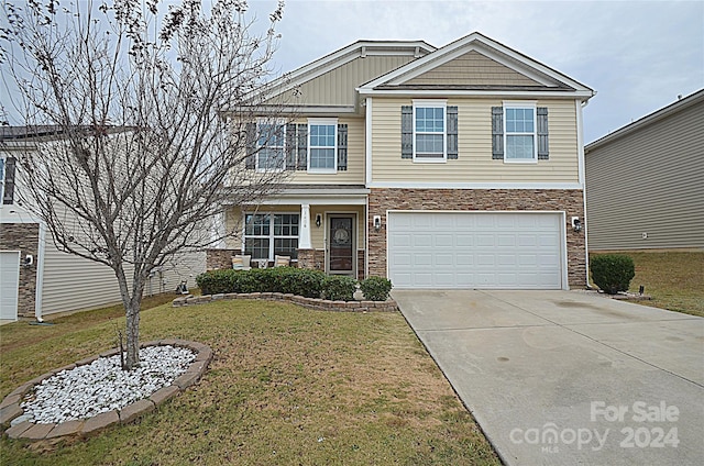 view of front of home featuring a front lawn and a garage