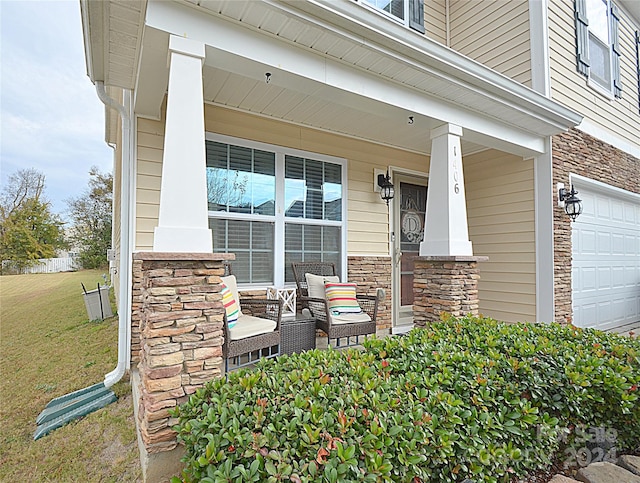 property entrance with a lawn, a porch, and a garage