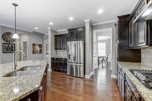 kitchen featuring decorative backsplash, appliances with stainless steel finishes, sink, and dark brown cabinetry