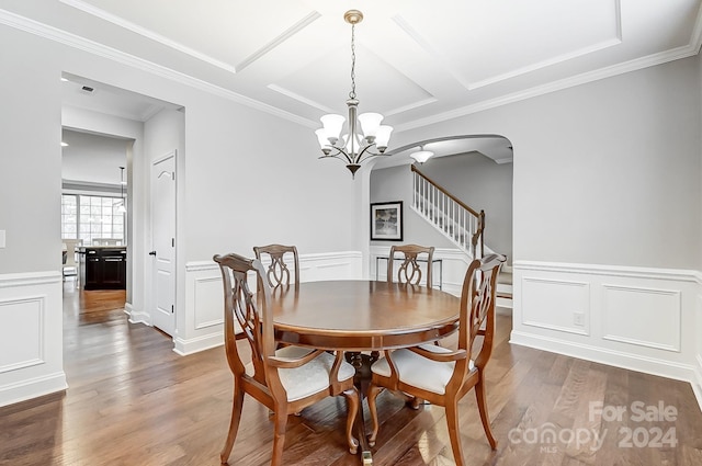 dining space with ornamental molding, dark wood-type flooring, and a chandelier