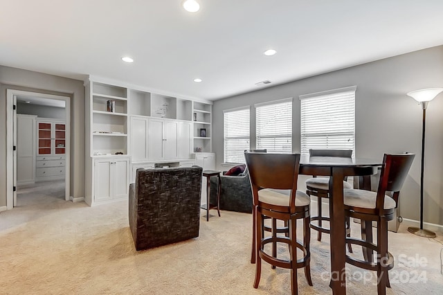 dining room featuring light colored carpet