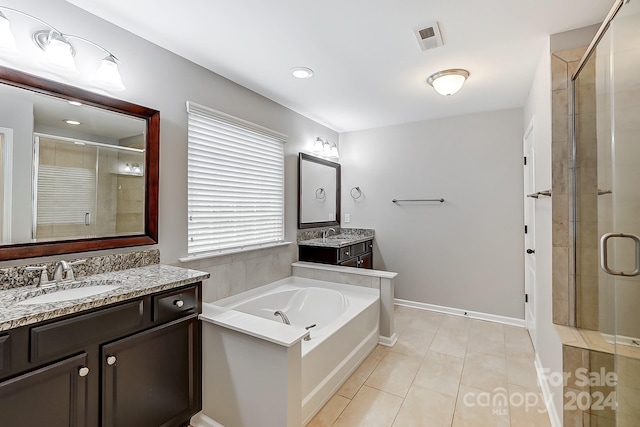 bathroom with vanity, plus walk in shower, and tile patterned flooring