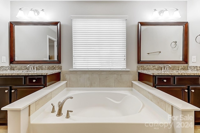 bathroom featuring vanity and a bath