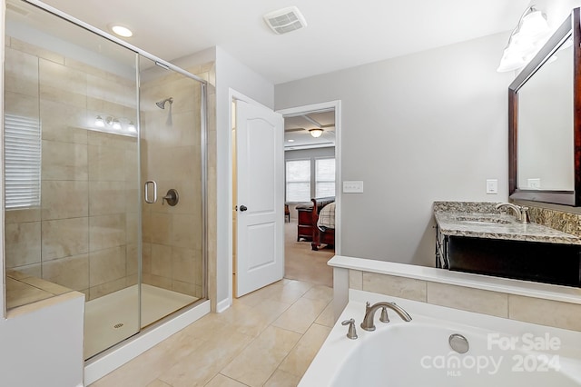 bathroom with vanity, tile patterned flooring, and a shower with door