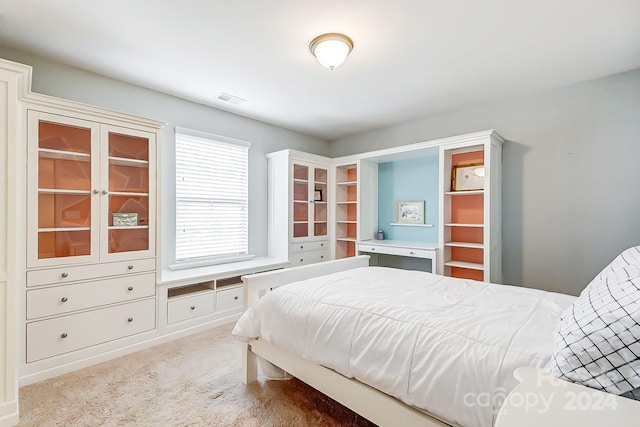 bedroom with light colored carpet