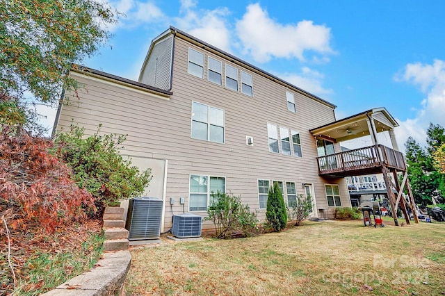 rear view of property featuring central AC unit and a yard