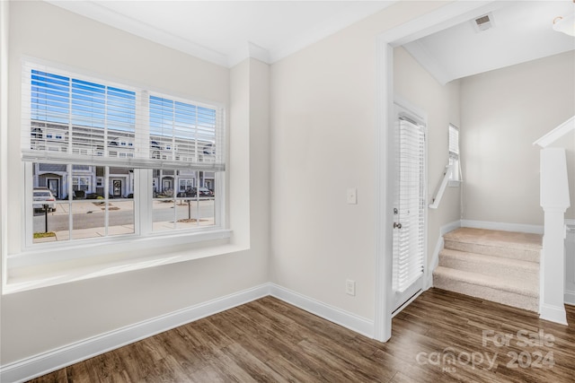 interior space with wood-type flooring and ornamental molding